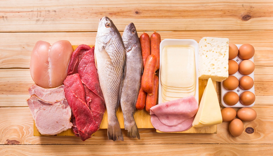 Group of important proteins, meats, fish, dairy, eggs, white meat on a wooden table as background, Shot from above