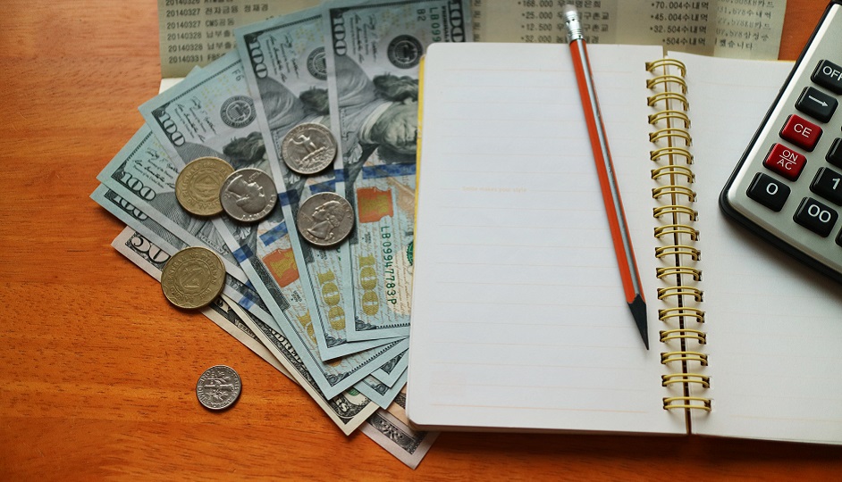 Financial analytics: money, note, calculator and a pen