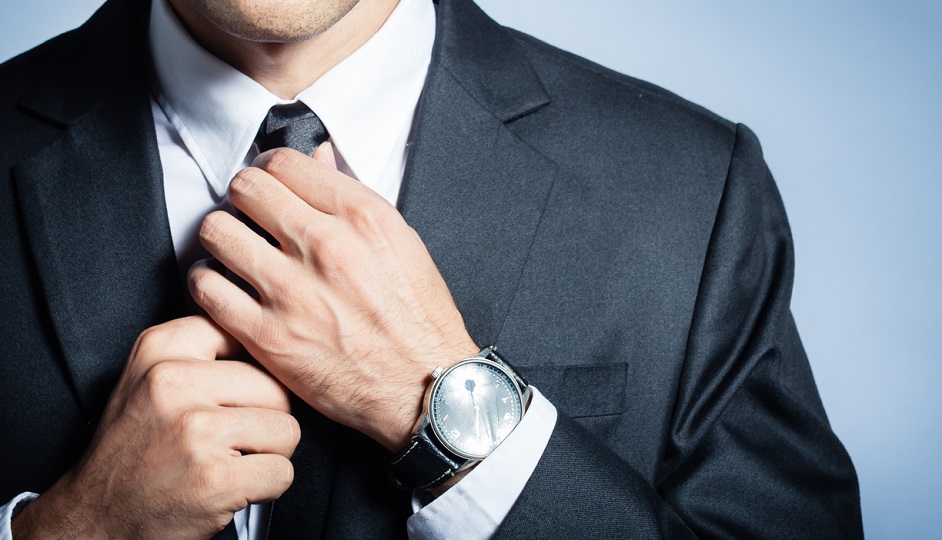 Businessman fixing his tie