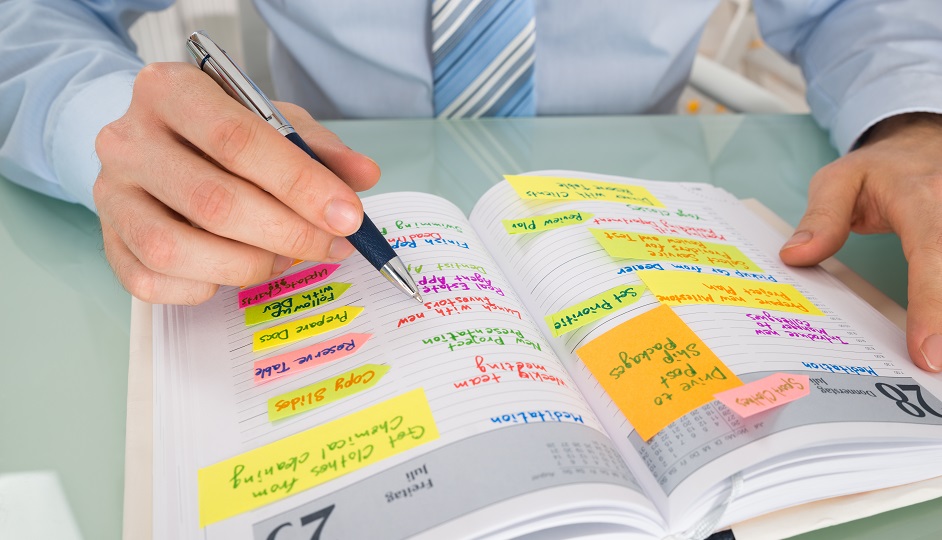 Businessman Writing Note In Diary